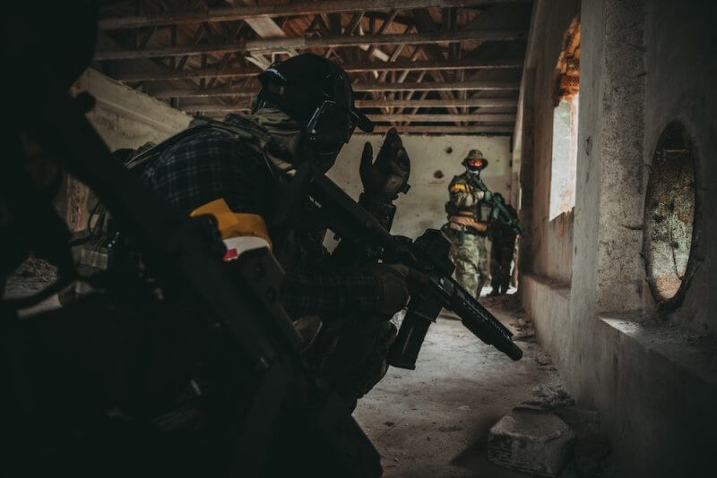 A group of airsoft players in an abandoned building